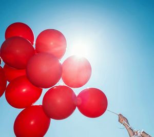 Low angle view of red balloons against clear sky
