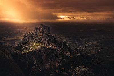 Scenic view of rock formation against sky during sunset