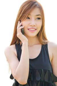 Portrait of a smiling young woman over white background