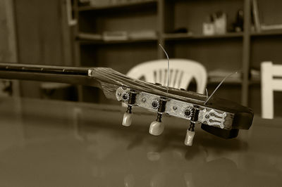 Close-up of guitar on table