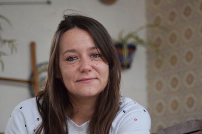 Close-up portrait of mid adult woman at home