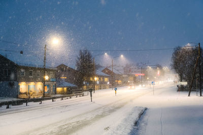 Snow covered road at night