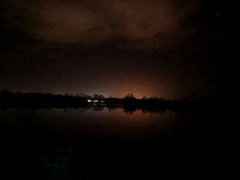 Scenic view of lake against sky at night