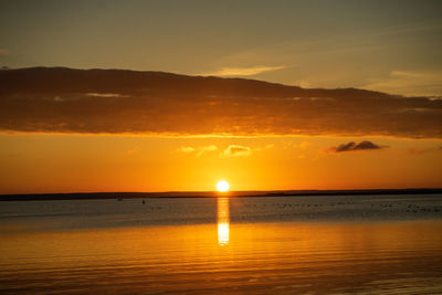 Scenic view of sea against romantic sky at sunset