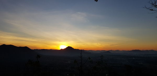 Scenic view of silhouette mountains against sky during sunset