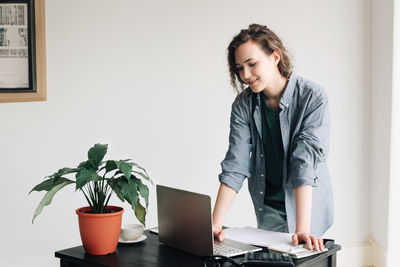 Side view of young businesswoman working at office