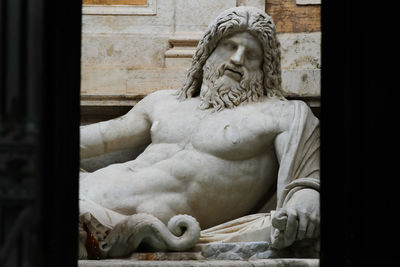 Close-up of statue against stone wall