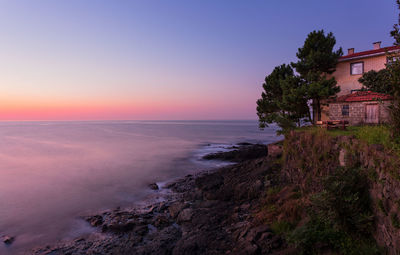 Scenic view of sea against clear sky during sunset