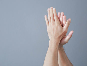 Close-up of woman hand against white background