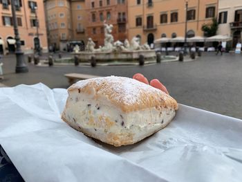 Close-up of ice cream on table in city