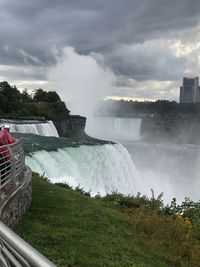 Scenic view of waterfall against sky