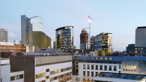 Modern buildings in city against clear sky