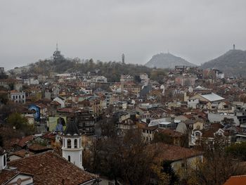 High angle view of houses in town against sky