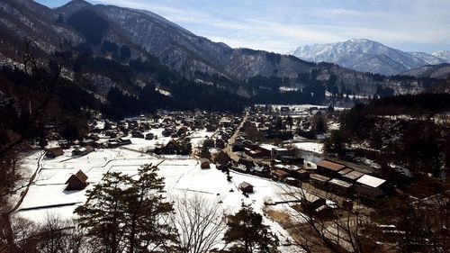 High angle view of townscape and mountains during winter