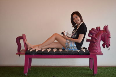 Portrait of smiling woman sitting on chair