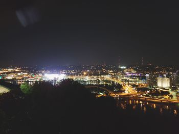 High angle view of illuminated buildings against sky at night