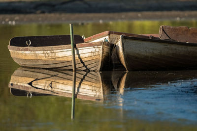 Old boat moored in lake