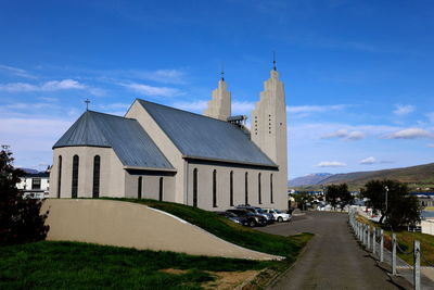 Building by road against sky