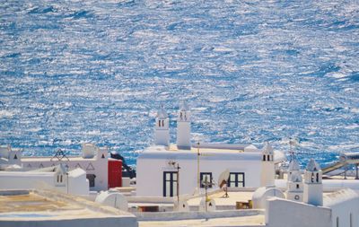 Roof of a traditional greek building with aegean sea in the background - high angle view of sea