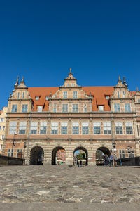 Building against the clear blue sky, the entry gate in the gdansk old town. 