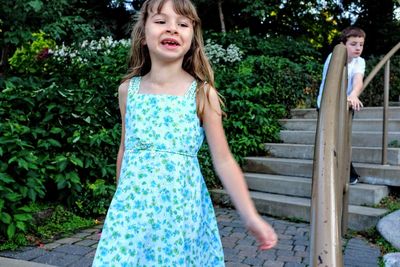 Portrait of a smiling girl standing outdoors