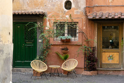 Potted plant outside house with two seat s and a table