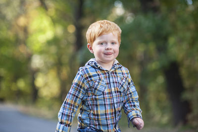 Portrait of boy standing outdoors