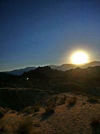 Scenic view of mountains against clear sky during sunset