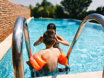 Boy and girl in swimming pool
