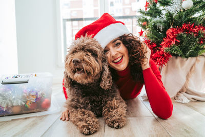 Portrait of happy young woman with dog in background