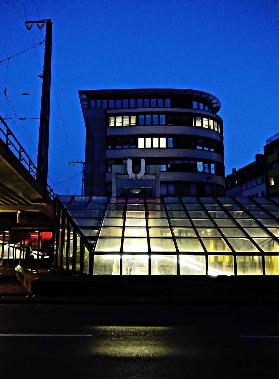 ILLUMINATED BUILDING AGAINST SKY AT NIGHT