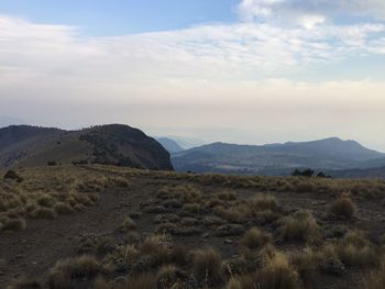 Scenic view of landscape and mountains against sky