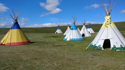 Clothes drying on field against sky