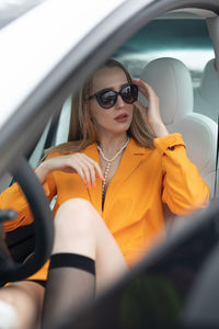 Portrait of woman sitting in car