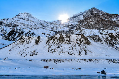 Scenic view of snowcapped mountains against sky during winter