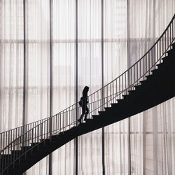 Full length of woman standing on railing