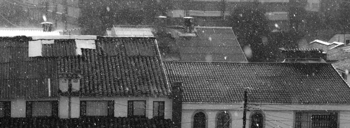 Buildings seen through wet window during winter