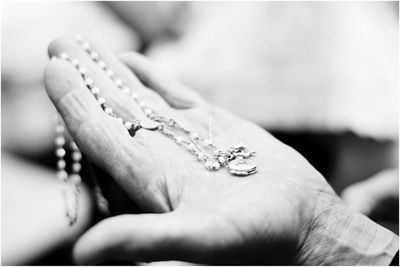 Close-up of woman holding necklace