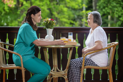 Woman sitting on chair at table