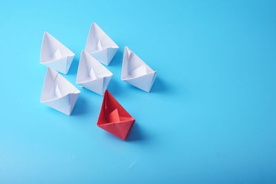 High angle view of paper flag against blue background