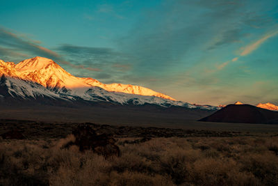 Scenic view of snowcapped mountains against sky during sunset