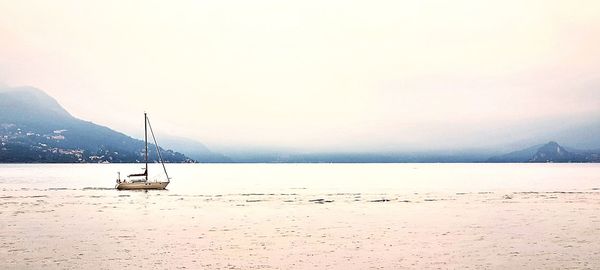 Sailboats on sea against sky