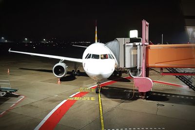 Airplane on airport runway at night