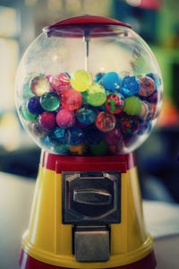 Close-up of multi colored toys in glass container