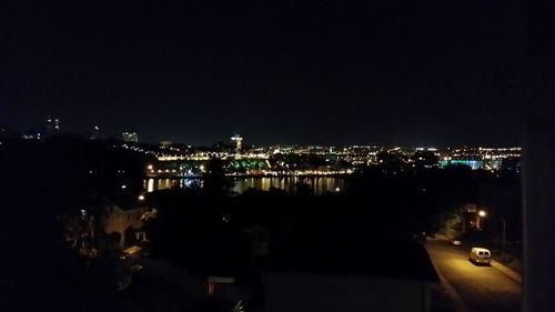 High angle view of illuminated buildings against sky at night