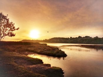 Scenic view of lake against sky during sunset