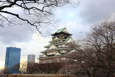 Low angle view of buildings against cloudy sky