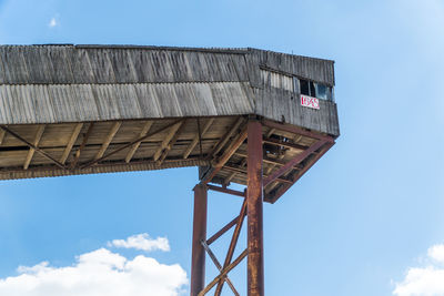 Low angle view of water tower against blue sky