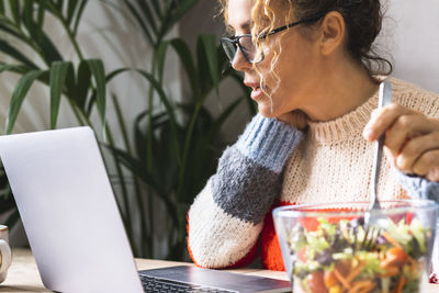 Young woman using laptop on table