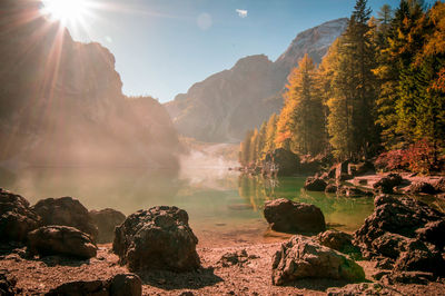 Scenic view of lake braies and mountains against sky during autumn